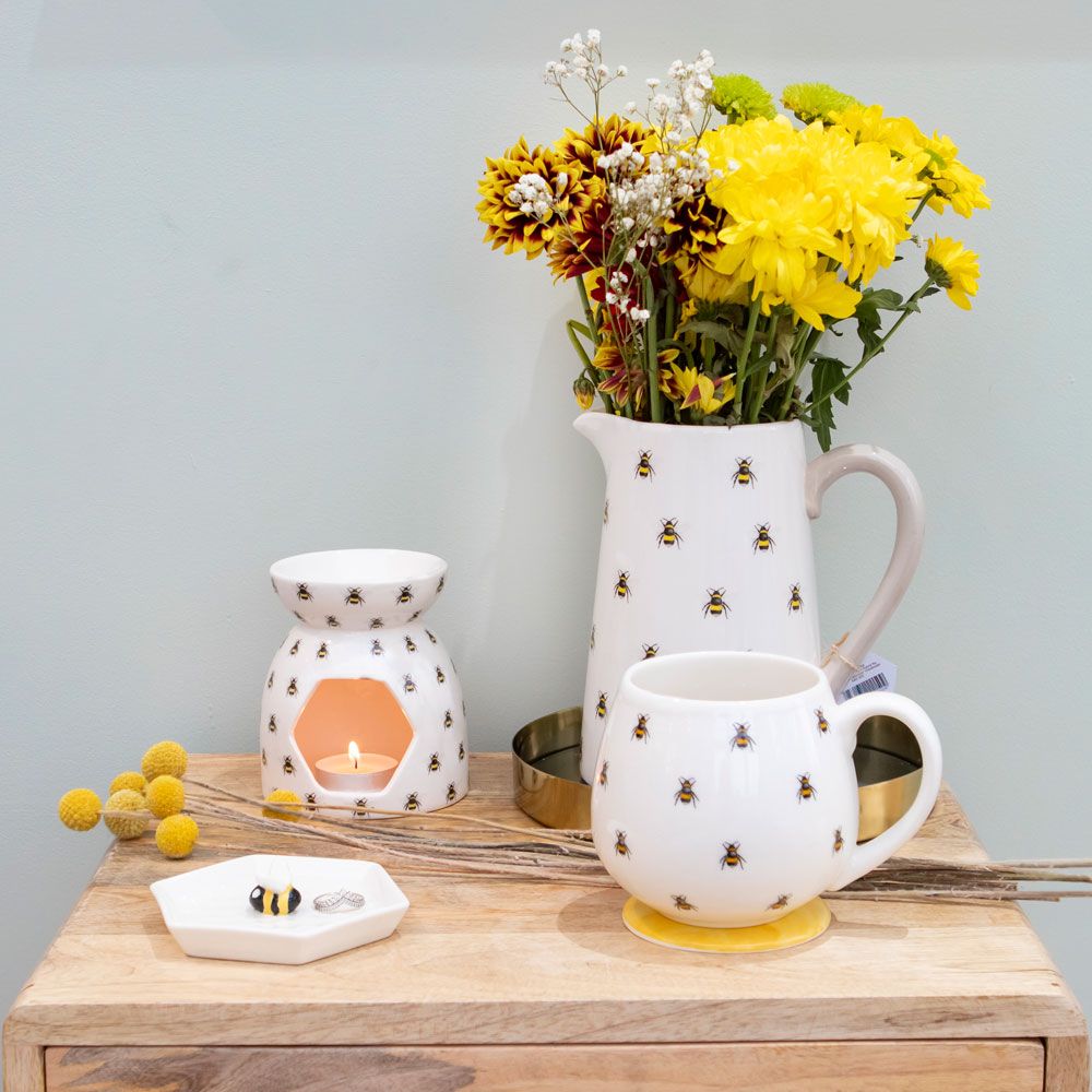 Bee Themed Ceramic Items - Burner, Jug, Mug, and Trinket Dish, Arranged on Wooden Block Table with Flowers