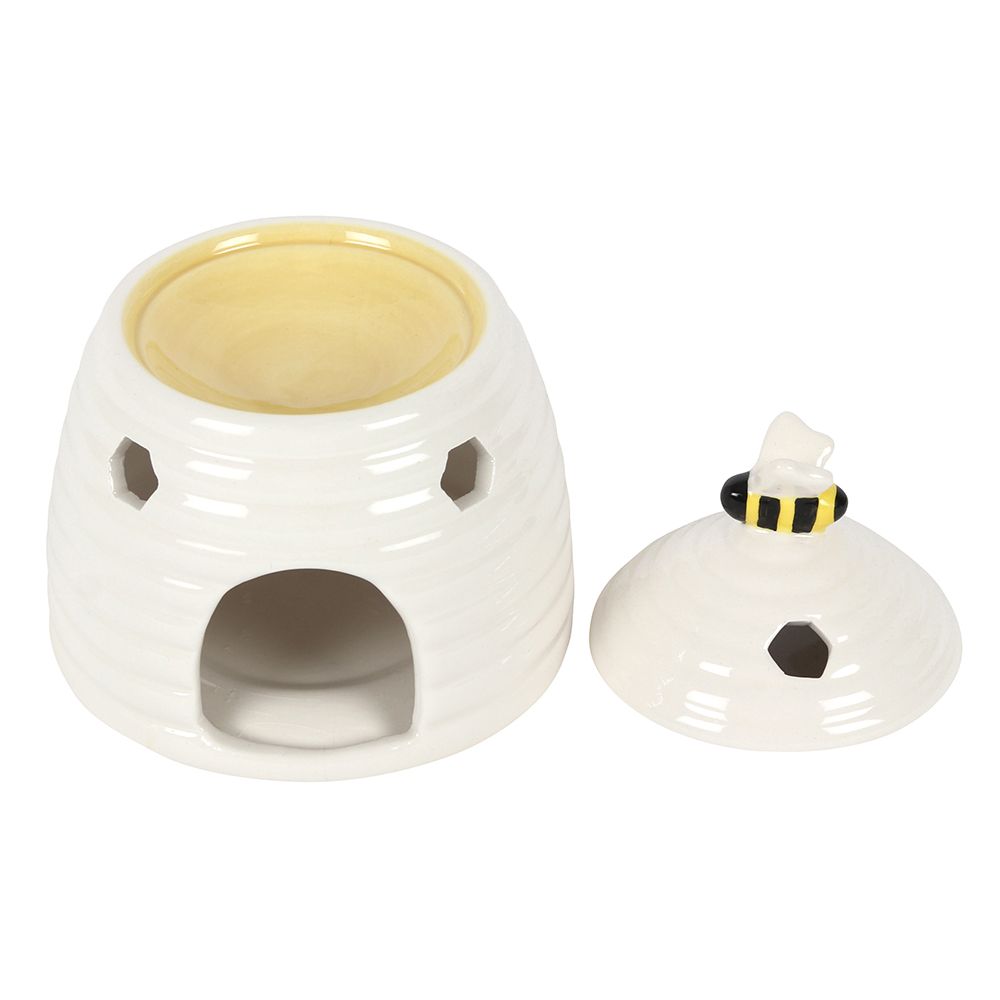 White Beehive Burner: Lid Off, Burner Well with Molten Wax/Oil, White Background